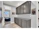Hallway view of built in grey cabinets and door to the bedroom at 8102 Villa De La Playa St, Las Vegas, NV 89131