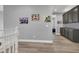 Hallway featuring a set of dark cabinets along with several pieces of artwork hanging on the light-gray wall at 8102 Villa De La Playa St, Las Vegas, NV 89131