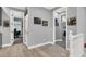 Bright hallway with wood floors and decorative art leading to office and other rooms at 8102 Villa De La Playa St, Las Vegas, NV 89131