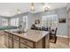 Bright kitchen featuring granite countertops, wooden cabinets, pendant lighting and a dining area at 8102 Villa De La Playa St, Las Vegas, NV 89131