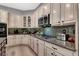 Gourmet kitchen featuring granite countertops, modern appliances, and custom cabinetry at 8102 Villa De La Playa St, Las Vegas, NV 89131