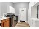 Well-organized laundry room with cabinets and a utility sink at 8102 Villa De La Playa St, Las Vegas, NV 89131