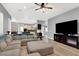 Bright and airy living space with a sectional sofa, entertainment center, and seamless flow to the kitchen at 8102 Villa De La Playa St, Las Vegas, NV 89131