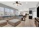 Open-concept living area with a large sectional sofa and view into the adjacent kitchen at 8102 Villa De La Playa St, Las Vegas, NV 89131