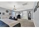 Bright main bedroom with carpet, chandelier, sitting area, and lots of natural light at 8102 Villa De La Playa St, Las Vegas, NV 89131