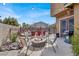 Inviting outdoor patio featuring a cozy fire pit, seating, and an open view of the backyard pool and waterfall at 8102 Villa De La Playa St, Las Vegas, NV 89131