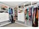 Spacious walk-in closet with custom shelving, drawers, and hanging rods for organization at 8102 Villa De La Playa St, Las Vegas, NV 89131