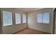 Bedroom featuring carpet flooring, three windows with blinds, and neutral paint at 8120 Finch Feather St, Las Vegas, NV 89143