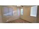 Bedroom with neutral carpet, three windows bringing in natural light, and a ceiling fan at 8120 Finch Feather St, Las Vegas, NV 89143