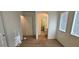 Neutral bedroom featuring carpet, two windows, and passageway to the bathroom at 8120 Finch Feather St, Las Vegas, NV 89143