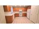 Kitchen features wooden cabinets, white appliances, and a tile backsplash at 8120 Finch Feather St, Las Vegas, NV 89143