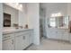 This bright bathroom offers double sinks, a glass enclosed shower, and modern finishes at 827 Klamath Springs St, Henderson, NV 89011