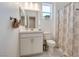 Bathroom featuring a shower with patterned curtains, a toilet, and a vanity with a white countertop at 827 Klamath Springs St, Henderson, NV 89011