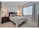 This bedroom is complete with a plush carpet, a double bed, and side tables at 827 Klamath Springs St, Henderson, NV 89011