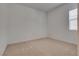 Clean, minimalist bedroom with carpeted floors and a window, offering a blank canvas for personalization at 827 Klamath Springs St, Henderson, NV 89011