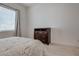 Bright bedroom featuring a wooden dresser and a comfortable bed near a window with natural light at 827 Klamath Springs St, Henderson, NV 89011