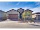Charming single-story home featuring desert landscaping, brick driveway, and a stone-accented facade on a clear day at 827 Klamath Springs St, Henderson, NV 89011