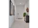 Bright hallway features tile floors, fresh white paint, and contemporary decor at 827 Klamath Springs St, Henderson, NV 89011