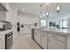 Stylish kitchen features white cabinetry, stainless steel appliances, and a center island at 827 Klamath Springs St, Henderson, NV 89011