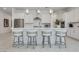Kitchen island with bar stools, stainless steel appliances, and white cabinets at 827 Klamath Springs St, Henderson, NV 89011