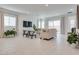 Bright and airy living room featuring tile floors, modern furnishings, and ample natural light at 827 Klamath Springs St, Henderson, NV 89011