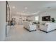 Expansive living room with tile flooring, modern furnishings, and seamless transition to the kitchen at 827 Klamath Springs St, Henderson, NV 89011