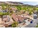 Beautiful aerial of a modern home with a tile roof surrounded by desert landscaping and mountains at 9 Rue Grimaldi Way, Henderson, NV 89011