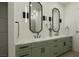 Stylish bathroom featuring a long vanity with marble countertops, modern mirrors and fixtures at 9 Rue Grimaldi Way, Henderson, NV 89011