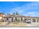 Attractive single story home featuring a tile roof, two-car garage and desert landscaping at 9 Rue Grimaldi Way, Henderson, NV 89011