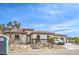 Beautiful single-story home with a three car garage, landscaped yard, and blue sky at 9 Rue Grimaldi Way, Henderson, NV 89011