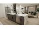 Contemporary kitchen island featuring marble countertops, stainless steel dishwasher, and adjacent dining area at 9 Rue Grimaldi Way, Henderson, NV 89011