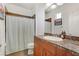 Well-lit bathroom featuring granite counters, a shower, and a modern design at 9050 W Tropicana Ave # 1102, Las Vegas, NV 89147