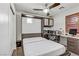 Cozy bedroom includes a murphy bed, desk, ceiling fan and shuttered windows creating a versatile and comfortable space at 9050 W Tropicana Ave # 1102, Las Vegas, NV 89147