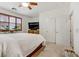 Bright bedroom with large bed, TV, shutters and access to ensuite bathroom at 9050 W Tropicana Ave # 1102, Las Vegas, NV 89147