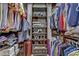Walk-in closet with clothing racks, shelving, and a small red suitcase at 9050 W Tropicana Ave # 1102, Las Vegas, NV 89147