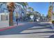 Gated community entrance featuring palm trees and colorful building facade, offering security and curb appeal at 9050 W Tropicana Ave # 1102, Las Vegas, NV 89147