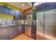 Modern kitchen featuring stainless steel appliances, dark wood cabinets and terracotta tile floor at 9050 W Tropicana Ave # 1102, Las Vegas, NV 89147