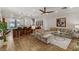 Open-concept living space with hardwood floors, modern furnishings and bar seating at 9050 W Tropicana Ave # 1102, Las Vegas, NV 89147