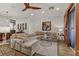 This large living room features a sectional sofa, modern ceiling fan, and a sliding door which opens to a patio at 9050 W Tropicana Ave # 1102, Las Vegas, NV 89147