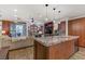 Open-concept living area with a granite island, stainless sink, and modern finishes at 9050 W Tropicana Ave # 1102, Las Vegas, NV 89147
