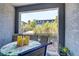 Balcony with outdoor seating, table, candles, and serene views of landscaping and nearby building at 9050 W Tropicana Ave # 1102, Las Vegas, NV 89147