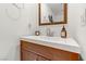 Powder room with a modern vanity, decorative mirror, and ample counter space at 9050 W Tropicana Ave # 1102, Las Vegas, NV 89147