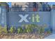 Exterior view of the community entrance sign with landscaping at 9050 W Tropicana Ave # 1102, Las Vegas, NV 89147