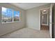 Well-lit bedroom featuring a large window with community views and neutral carpeting at 9053 Pearl Cotton Ave, Las Vegas, NV 89149