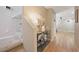 View of the staircase and hallway featuring wood floors and a decorative table with flowers at 9053 Pearl Cotton Ave, Las Vegas, NV 89149