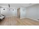 Empty living room featuring hardwood floors, track lighting, and neutral colored walls at 9053 Pearl Cotton Ave, Las Vegas, NV 89149