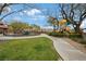 Community playground area with a play structure, grassy areas, and a paved pathway at 9053 Pearl Cotton Ave, Las Vegas, NV 89149