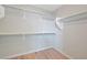 Bright walk-in closet with ample shelving and metal hanging rods for organized storage at 9053 Pearl Cotton Ave, Las Vegas, NV 89149