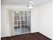 Bedroom featuring brown carpet, sliding glass doors to the backyard and a ceiling fan at 9672 Gunsmith Dr, Las Vegas, NV 89123