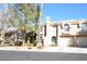 Charming two-story townhome with a private garage and well-maintained landscaping at 9672 Gunsmith Dr, Las Vegas, NV 89123